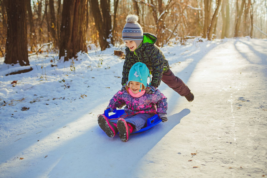 children snow sledding