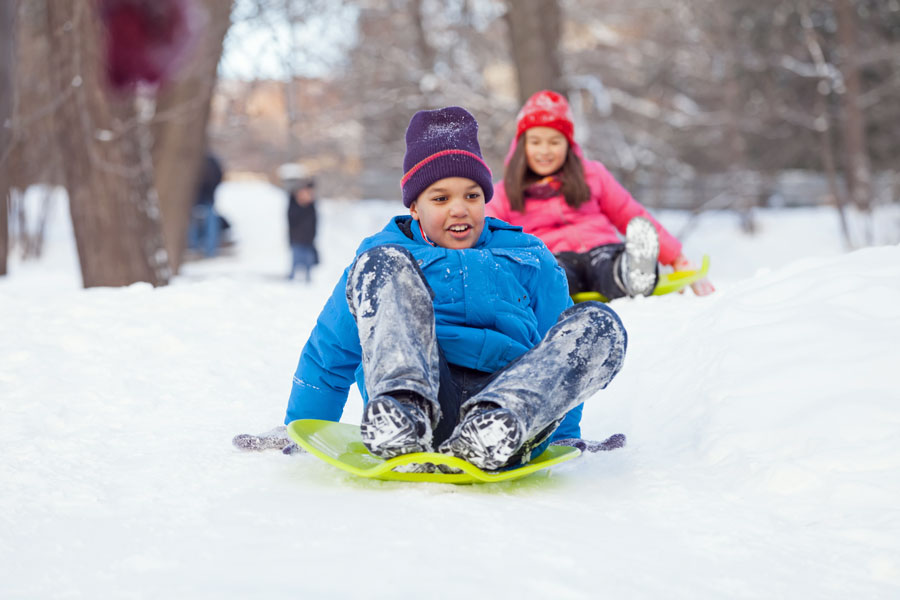 children snow sledding