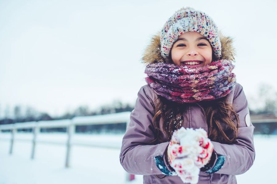 girl holding a snowball