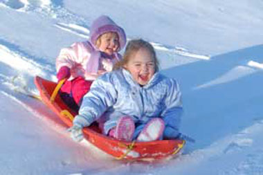 children snow sledding