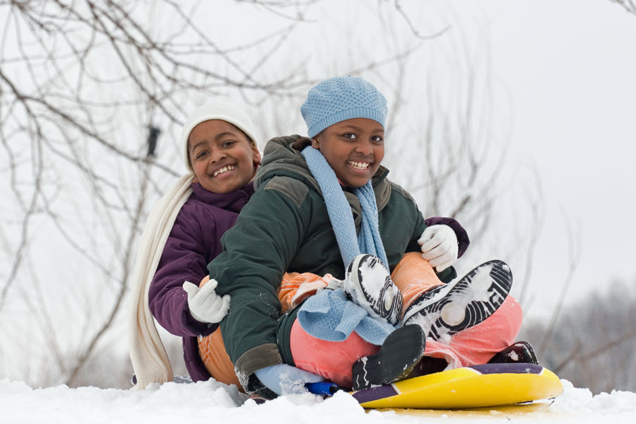 children snow sledding