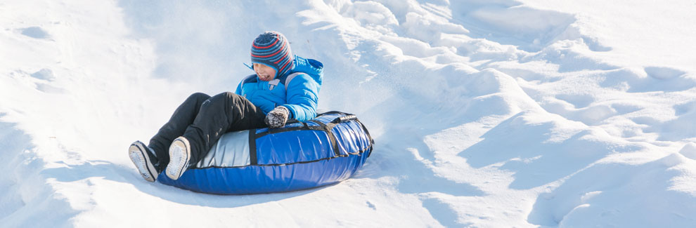 girl riding snow tube, California